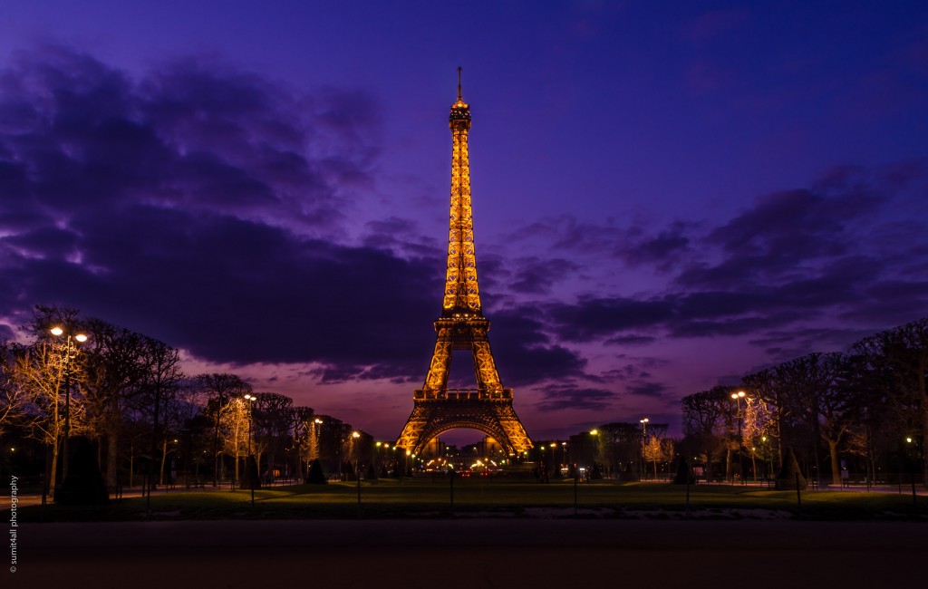 The Eiffel Tower during a cloudy sunset evening