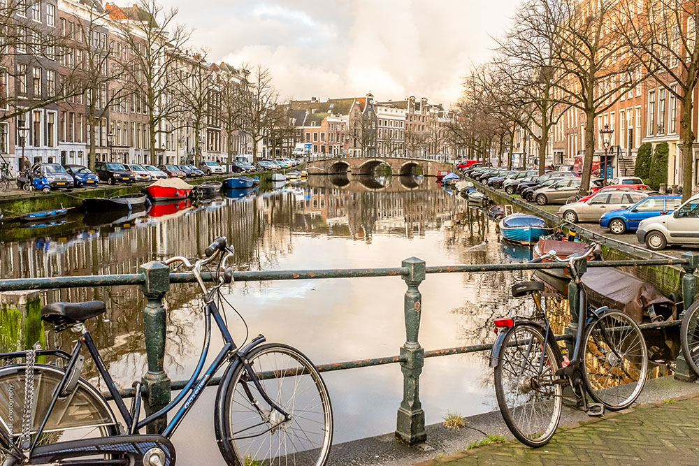 Bikes on a Bridge over a Canal in Amsterdam Bikes on a Bridge over a Canal in Amsterdam