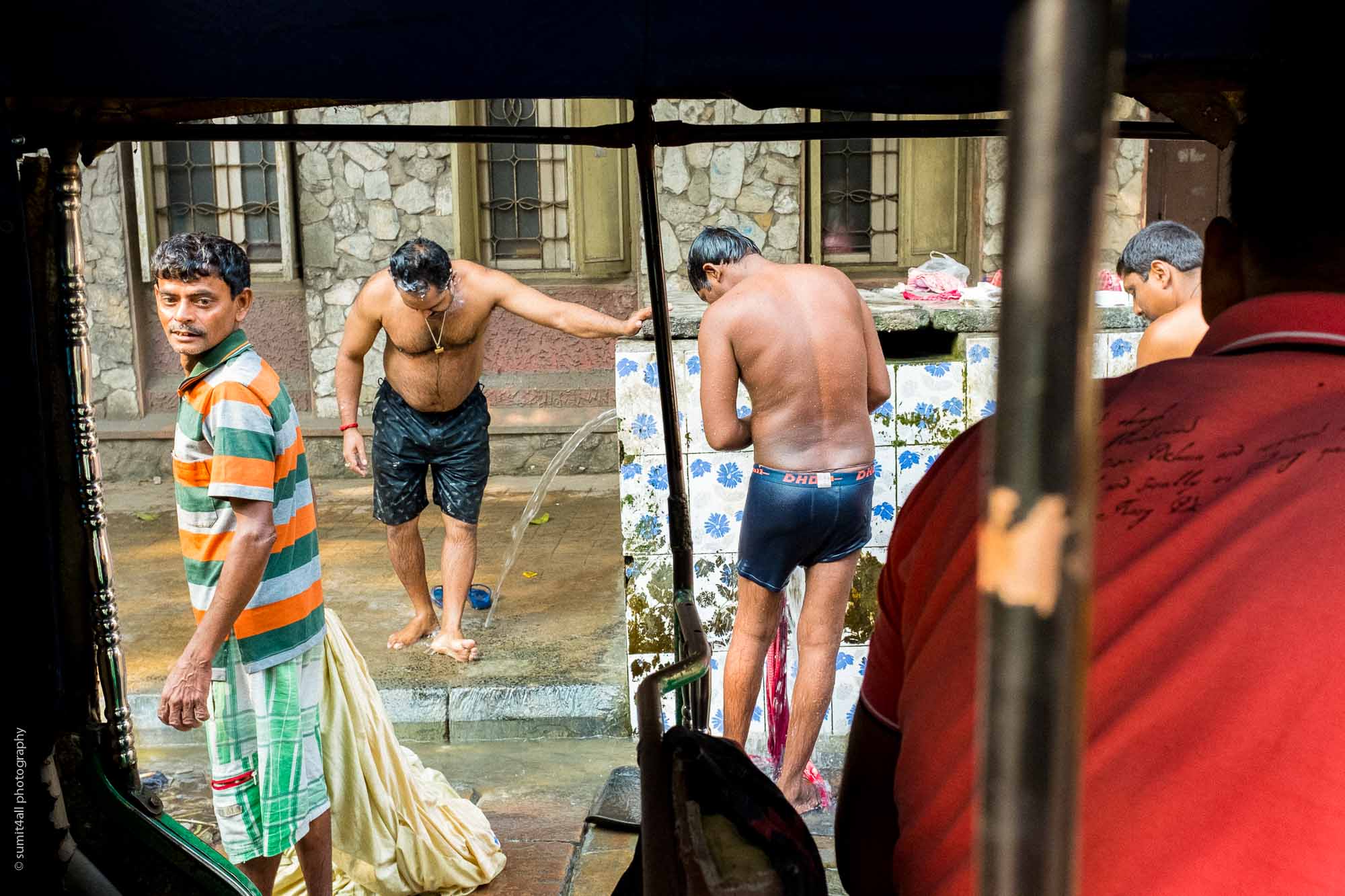 People bathing on the streets in Kolkata